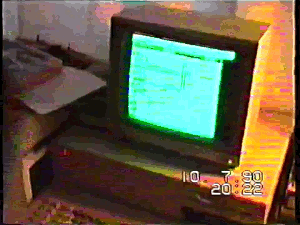 An IBM PC compatible computer on a desk running Simcity in 1990