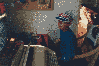 Pekka Leppaluoto in front of a desk with a Sinclair Spectrum microcomputer in 1985.
